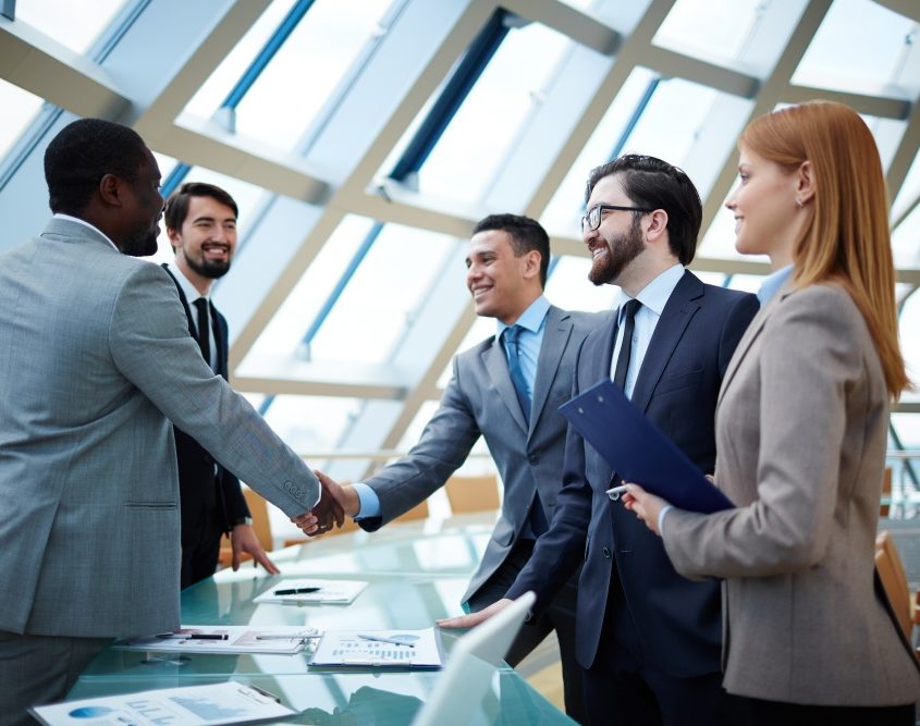 Two businessmen handshaking after striking grand deal